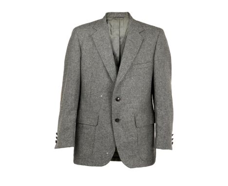 A gray wool suit jacket, personally-owned by Dennis Hopper. The smoke gray, single vent wool jacket features gray suede elbow