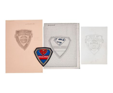 A group of three concept sketches including two prints, an original hand-drawn sketch, and a single special effects crew patc
