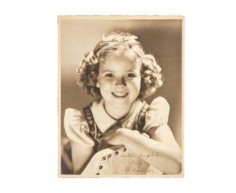 A vintage publicity photograph of Shirley Temple inscribed "To Alec Templeton / Love," and signed by her. Some faint text has