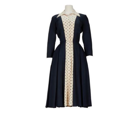 A navy and cream dupioni silk dress with polka-dot pattern accents designed for Maureen O'Hara as Min Wead in the film The Wi