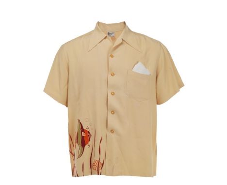 A pale yellow "tropical fish" button-down shirt, personally owned by comedian/actor John Belushi. The polyester, short-sleeve