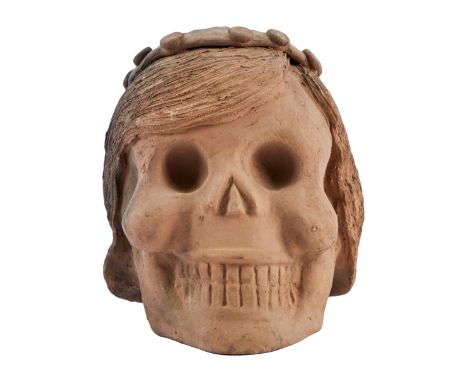 A hollow, black and brown ceramic skull with hat and hair details, from the collection of&nbsp;Dennis Hopper.Approx. 8 x 7 x 