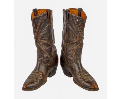A pair of vintage brown cowboy boots, personally owned and worn by Dennis Hopper. The espresso brown leather boots feature ta
