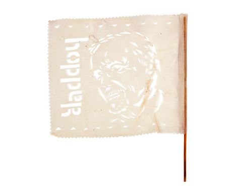 A fan-made tissue paper flag featuring a cut-out of Dennis Hopper's face and his last name in block lettering affixed to a wo