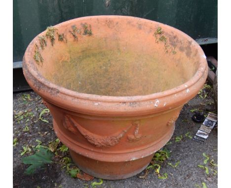 A terracotta planter, with Neo Classical flower swag design, 41cm high.