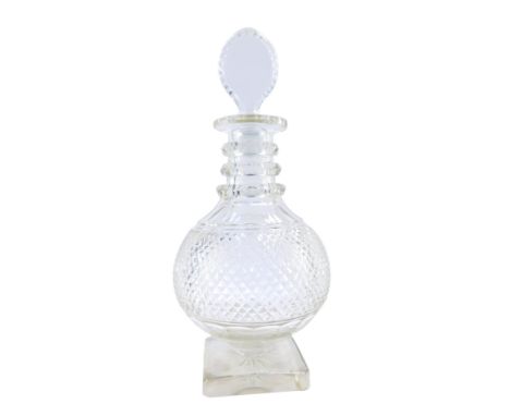 A Georgian style cut glass decanter, with a bull's eye stopper, of baluster form with a three ring collar, on a square star s