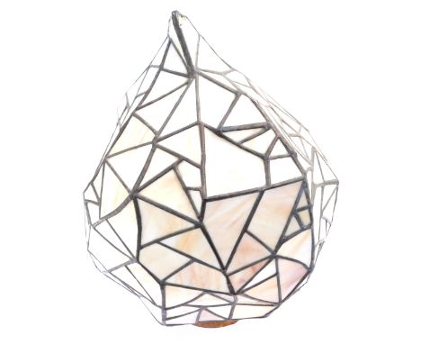 A Tiffany style lamp shade, of abstract design, with cream geometric panels, 50cm high.