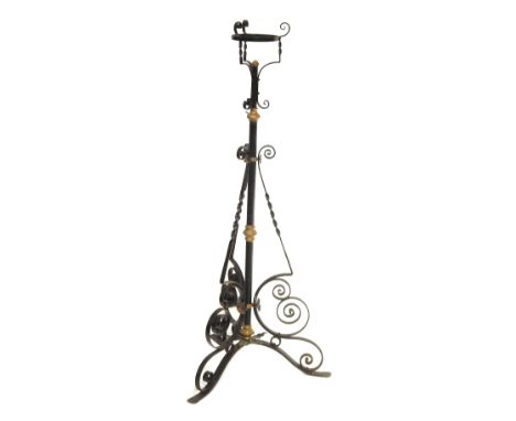 A Victorian wrought iron oil lamp base, in black finish with brass highlights, on tripod base, 115cm high.