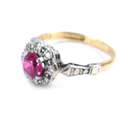 An 18ct gold and platinum cluster ring, with central garnet surrounded by tiny diamonds, white metal shoulders, size M, 2.5g 