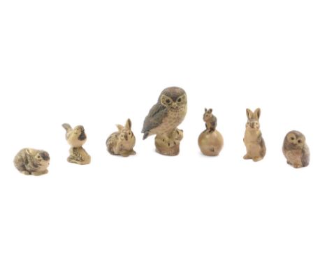 Seven Poole Pottery animal figures, comprising large owl, 22cm high, three rabbits, small owl, mouse on an apple, and a bird.