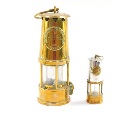 Two miners lamps, comprising a brass Eccles miners lamp, No 6, 23cm high, and a smaller example, 12cm high. (2)