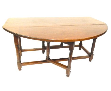 An 18thC style mahogany gate leg dining table, with three plank top on a turned base, 73cm high, 180cm wide, 150cm deep.