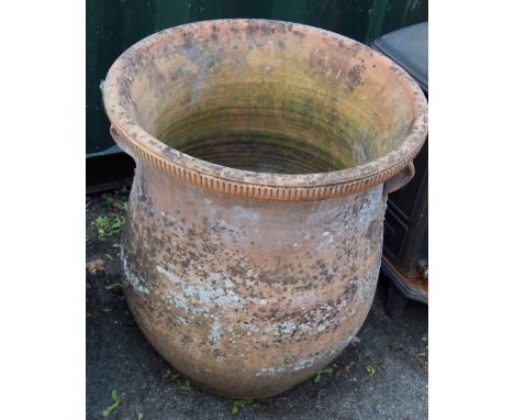 A terracotta planter, with ribbed border and flare vase, 57cm high.  