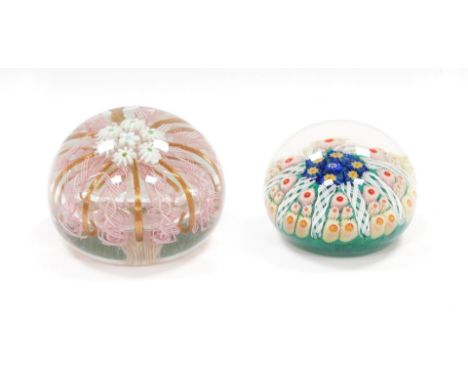 A Murano glass paperweight, decorated with daisies, pink latticino and gold ribbon strands, 9.5cm diameter, together with a c