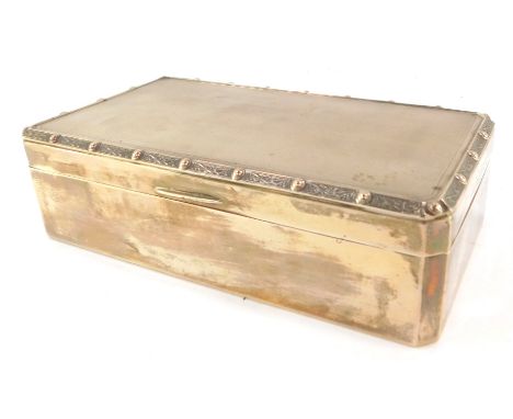 An Elizabeth II silver cigarette box, the Celtic banded top with engine turned decoration opening to reveal a wooden lined in