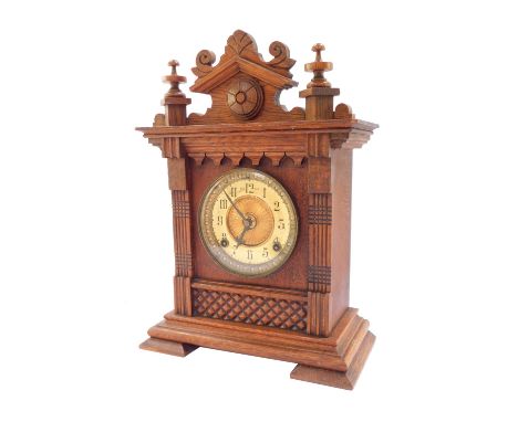 An late 19thC oak cased mantel clock, Ansonia Clock Co, Salem, Mass., brass dial with chapter ring bearing Arabic numerals, e