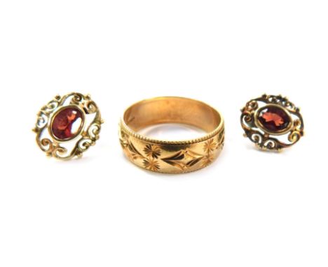 9ct gold jewellery, comprising a gold wedding band of etched floral design, size K½, a pair of garnet and gold framed stud ea