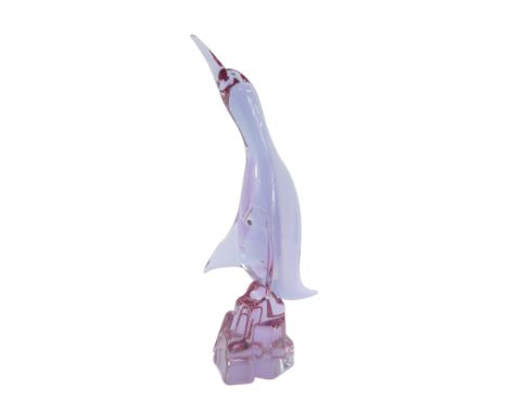 A Murano amethyst glass figure of a Cormorant, modelled perched on a rock, bears indistinct signature, 38.5cm high.