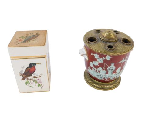 Two ceramics, comprising a Limoges pot pourri jar, with red ground and brass mounts, 10cm high, and a Carltonware painted bir