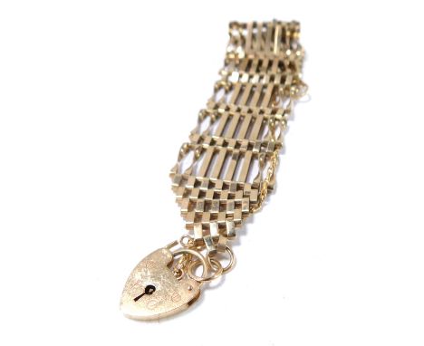A 9ct gold gate bracelet, of eight bar design, with safety chain and heart shaped padlock, 18g, 18cm long.
