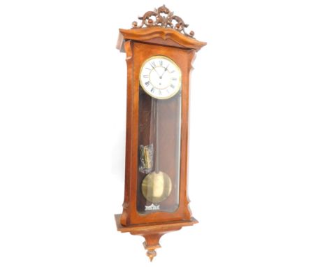 A late 19thC walnut cased Vienna wall clock, circular enamel dial bearing Roman numerals, thirty hour movement, the case with