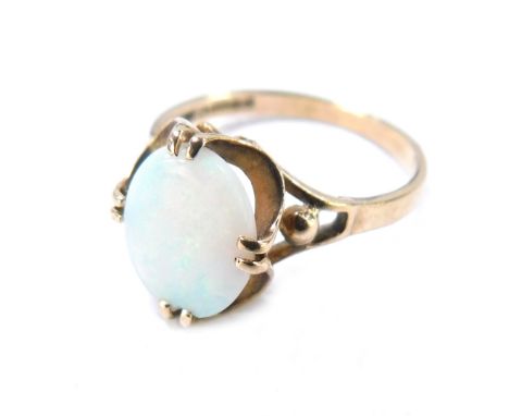 A 9ct gold opal dress ring, the oval opal in four twin claw setting, with fluted border and pierced design shoulders, size N½