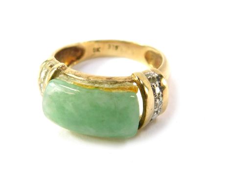 A jade and diamond dress ring, the oblong jade central stone with diamond set shoulders, yellow metal stamped 9k, size I½, 3.