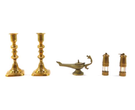 A small group of brass collectables, comprising a pair of candlesticks, 15cm high, a pair of miniature miner's lamps, 8cm hig