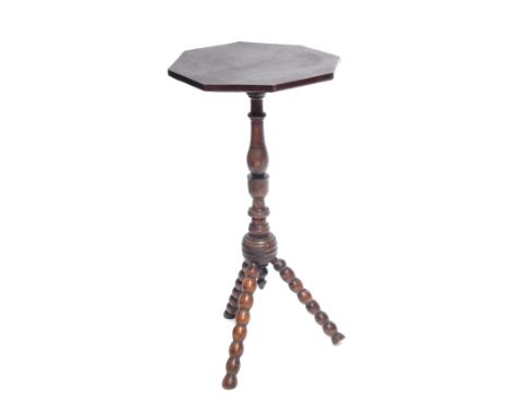 A late 19thC/early 20thC beech and elm gypsy table, with octagonal top, on bobbin turned tripod base, 72cm high, 40cm wide.