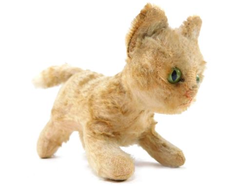 A Steiff vintage figure of a kitten, bears button to ear, 19cm wide.
