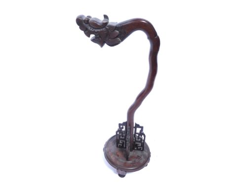 A Middle Eastern hardwood lamp stand, with dragon arch top, on a circular base, 60cm high.