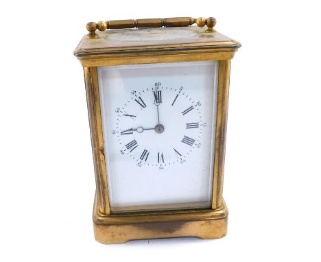 An early 20thC brass cased carriage timepiece, with white enamel dial bearing Roman and Arabic numerals, win barrel movement 