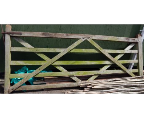 A wooden steeple five bar gate, 126cm high, 310cm wide.