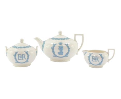 A Wedgwood Coronation 1953 tea set, white ground with blue raised relief, comprising teapot, sugar bowl and cover, and milk j