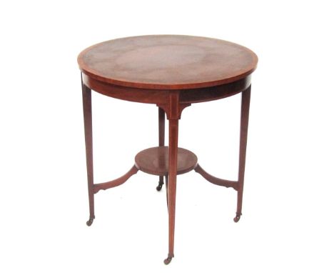 A late 19thC mahogany drum table, with light wood outer banded border, marquetry inlaid tapered legs, single shelf, terminati