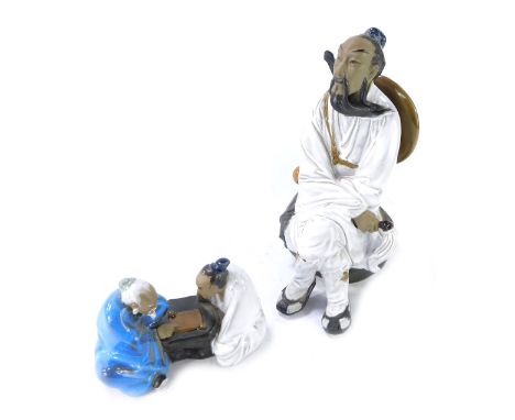 Two Chinese Mudmen figures, comprising a gentleman wearing cap, 26cm high, and two gentleman playing cribbage, 12cm high. (2)