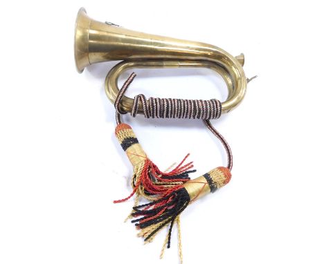 An early 20thC military copper and brass bugle, with Royal Artillery crest, 27cm wide.