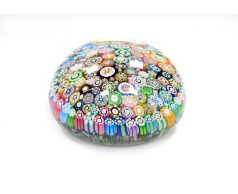 A Perthshire dated post millefiori glass paperweight, bearing a cone with initial T, and date cane for 1989, 8.5cm diameter.