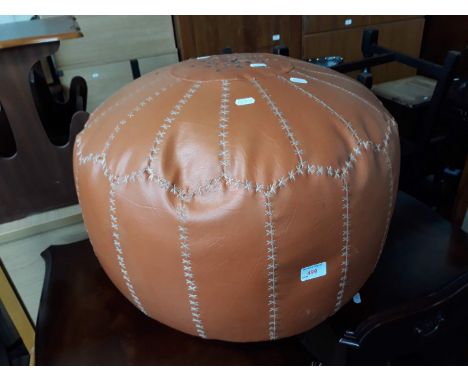 A retro faux leather pouffe 
