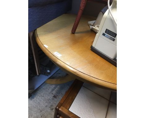 A light oak round dining table 
