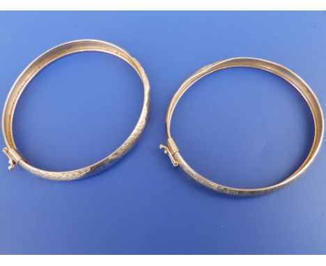A 585 yellow metal bangle and one other. (2)