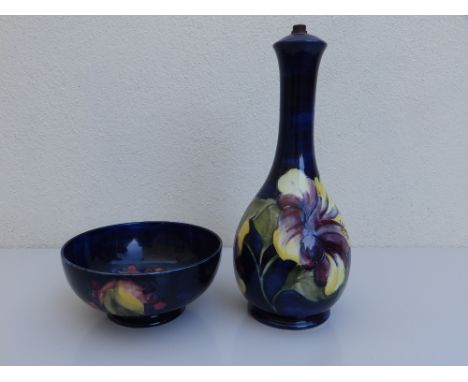 A Moorcroft leaf &amp; berry pattern dark blue ground bowl, 6.25" diameter, together with a hibiscus pattern lamp base - remn