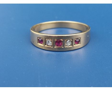 An 18ct gold band ring set with two small rose cut diamonds and three rubies.  Finger size N.