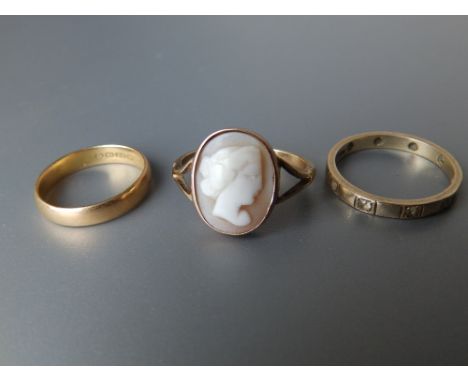 A 22ct wedding ring and two 9ct rings. (3)