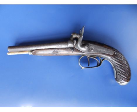 A 19thC Brazilian percussion lock double-barrel pistol, indistinct maker's marks, the fluted &amp; scale carved stock with hi