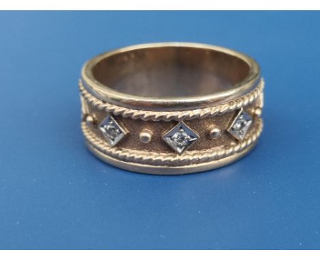 A 9ct gold dress band ring set with five small diamonds.  Finger size P/Q.