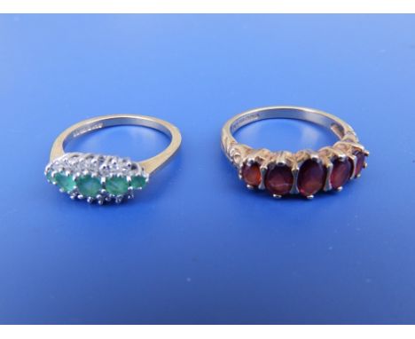 A 9ct garnet set ring and another set with emerald coloured stones. (2)