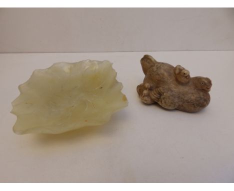 A Kochendorfer alabaster hen with chicks, 4" across together with a 6.5" leaf-carved pale green jade dish - both damaged. (2)