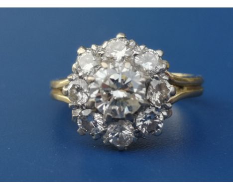 A diamond claw set cluster ring on 18ct shank.  Finger size H.