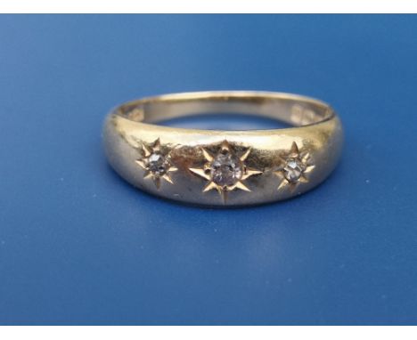 A gypsy set diamond 18ct gold band ring.  Finger size O.